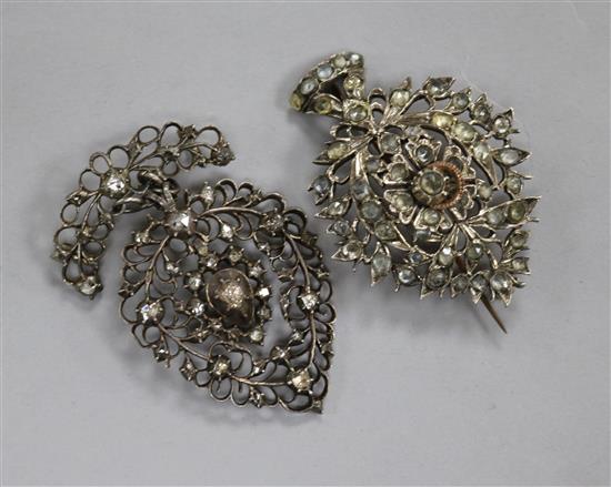 Two 19th century Indian white and yellow metal brooches, one set with rose cut diamonds, largest 57mm.